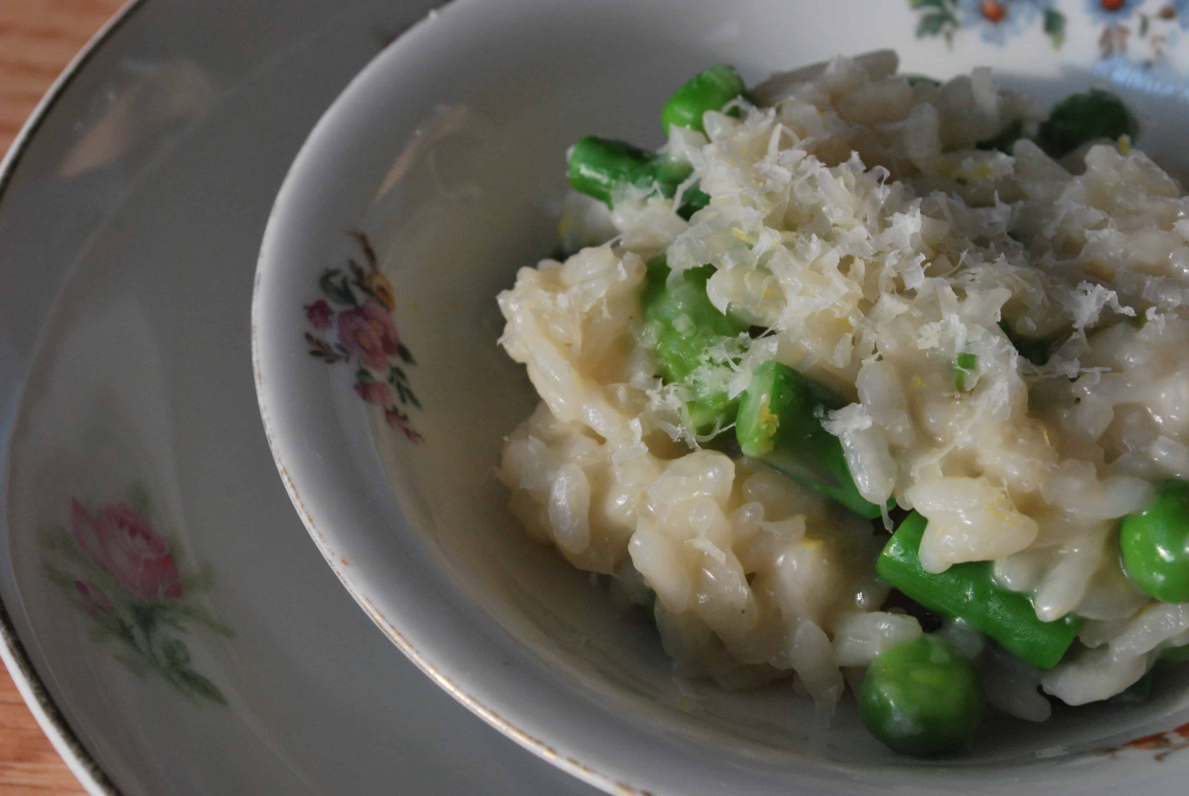 GreenPeaandAsparagusRisottoXCU a close up of Green Pea and Asparagus Risotto topped with grated parmesan cheese in a bowl