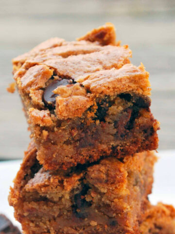 A stack of peanut butter cup cookie bars on a plate.