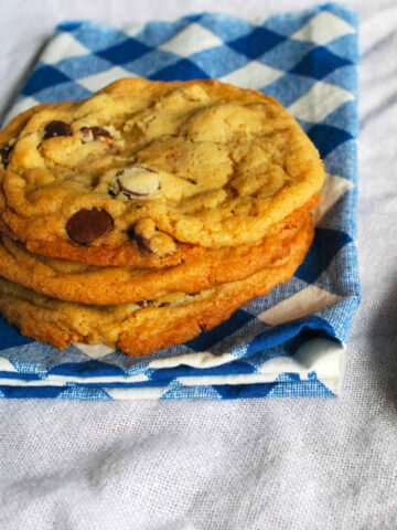 Chocolate chip cookies on a blue and white checkered napkin.