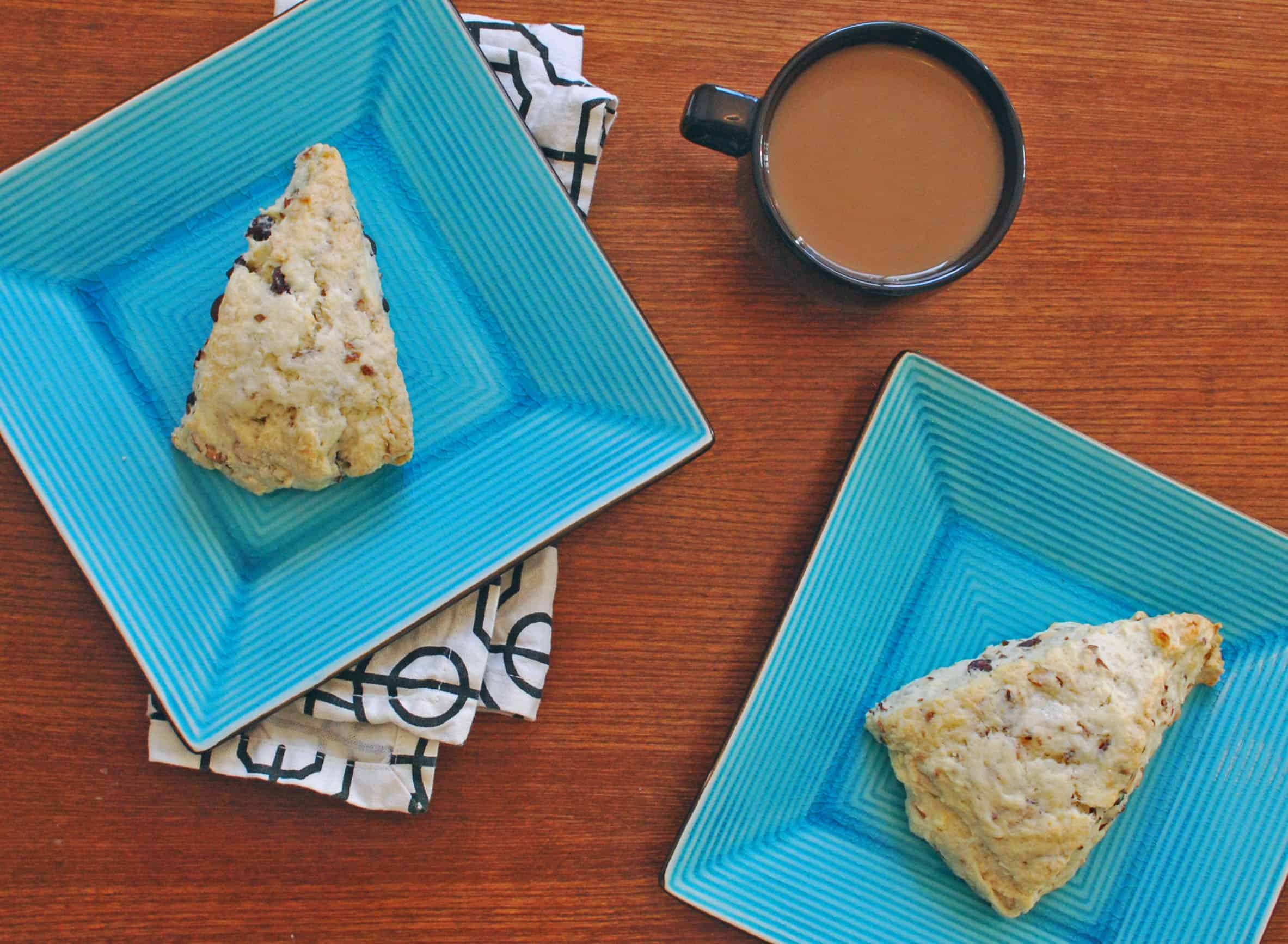 ChocCocSconesXOH Chocolate coconut almond scones on blue plates next to a cup of coffee