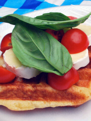 leige waffle with brie, tomatoes, and basil