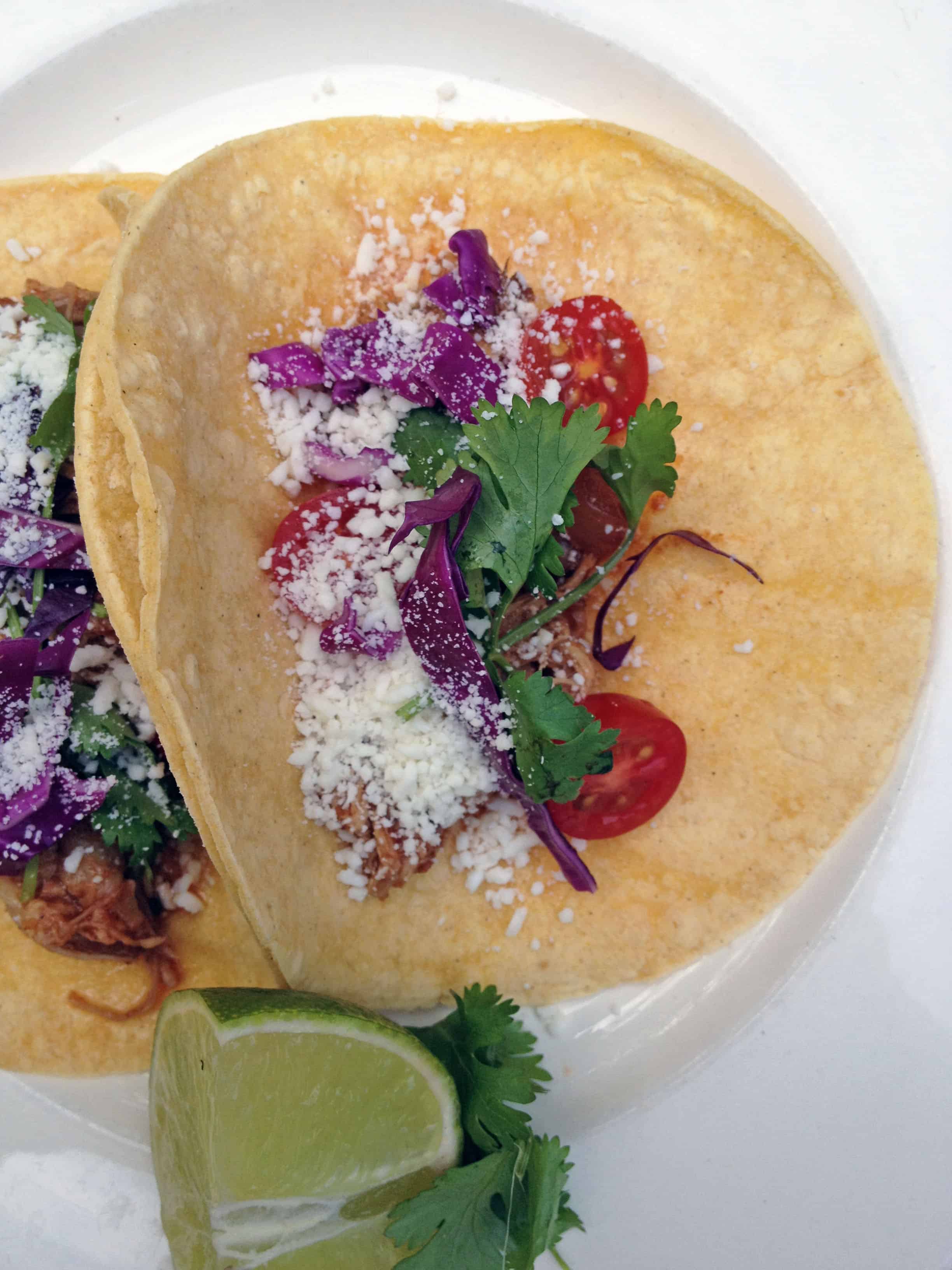 a close up of Slow Cooker Pork Tacos on a white plate