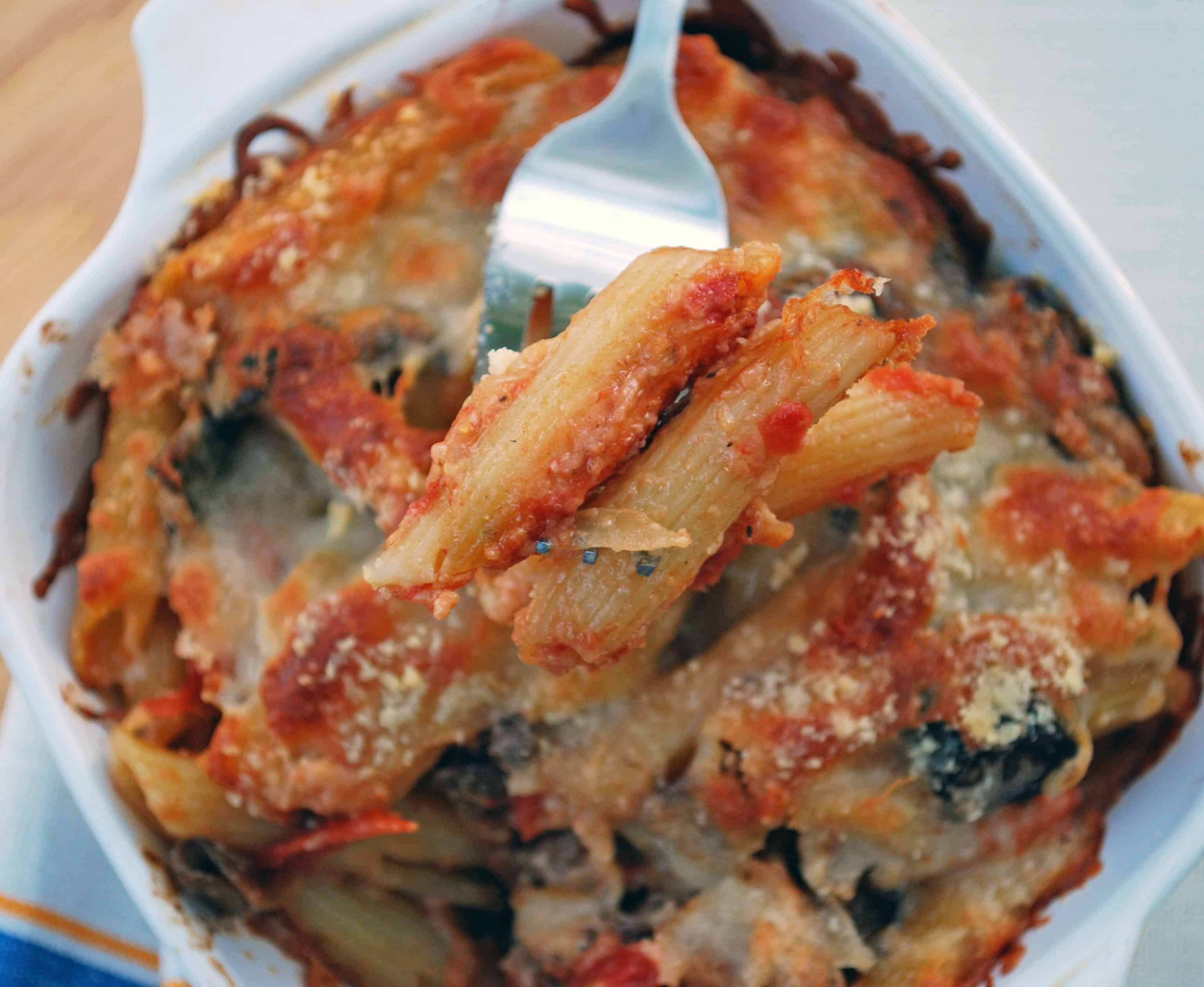 Baked Ziti a fork holding up a bite of baked ziti