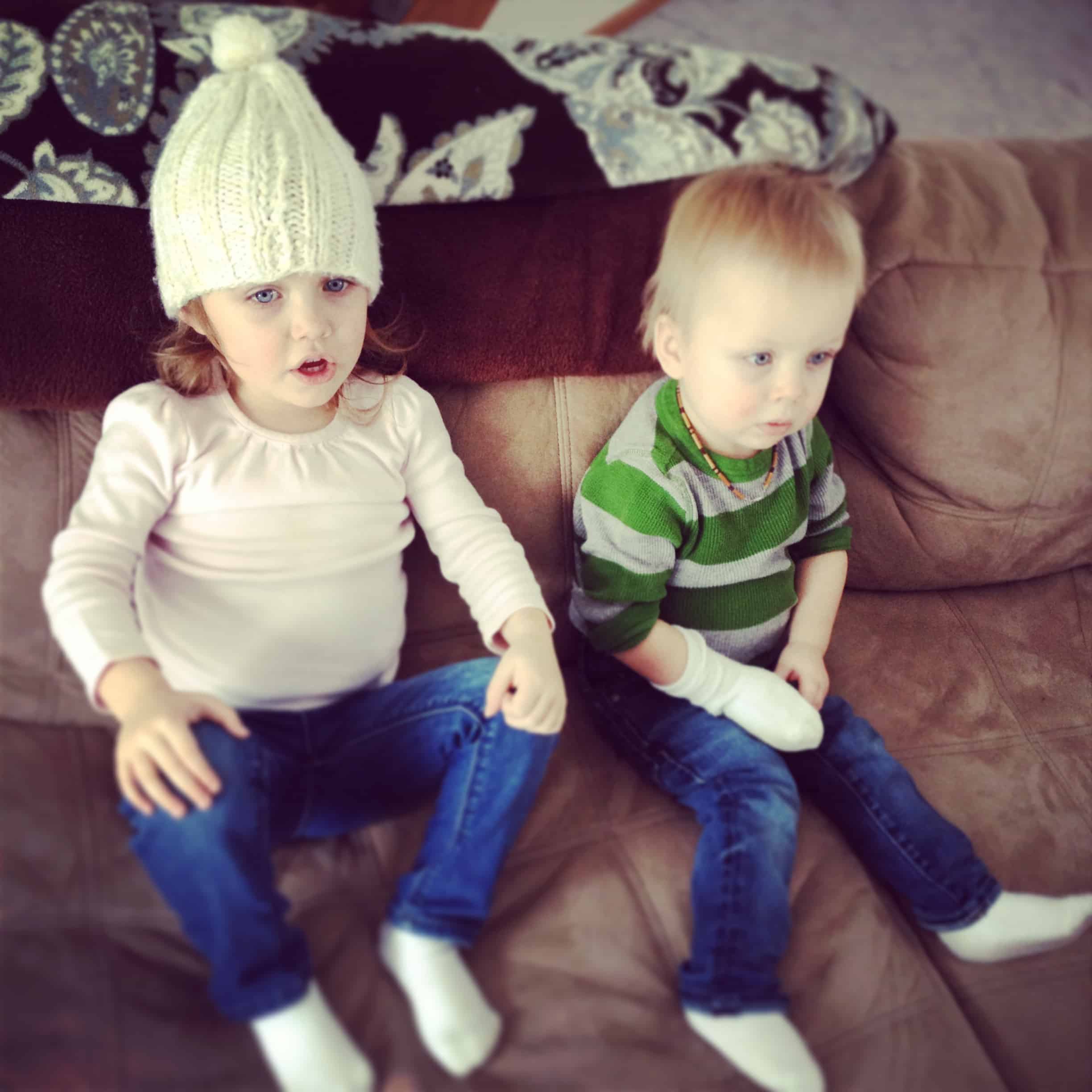 two children sitting on a couch