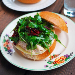 Balsamic and Sun-Dried Tomato Sandwich on a white plate with a floral border.