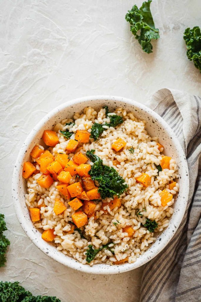 butternut squash risotto in a speckled bowl