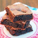 several brownies on a pink and white plate