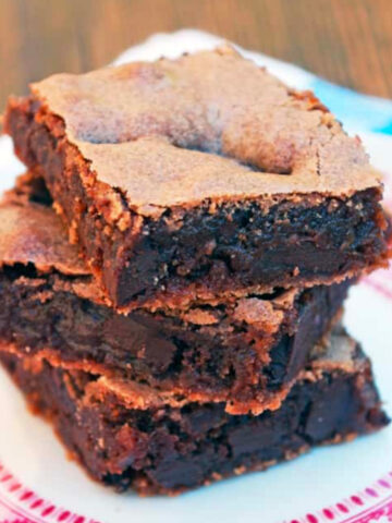 several brownies on a pink and white plate