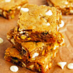 a stack of three white chocolate pistachio blondies.