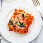 a lasagna roll on a white plate