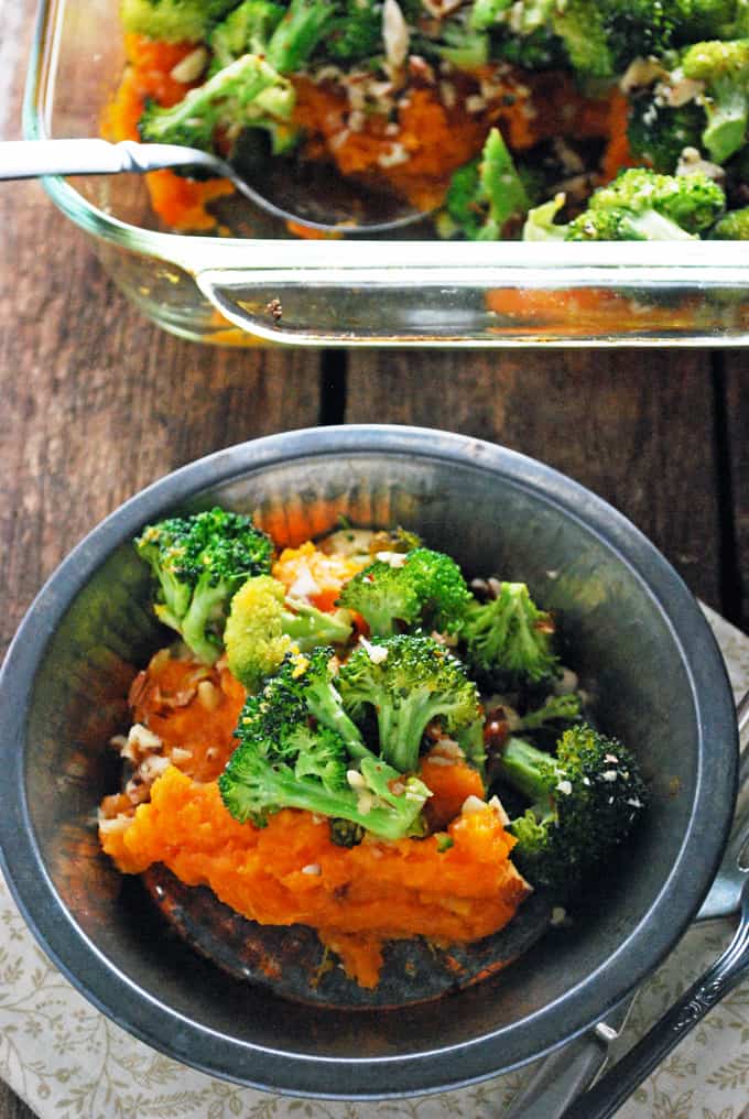 broccoli cheddar sweet potato casserole in a glass dish and some on a plate.