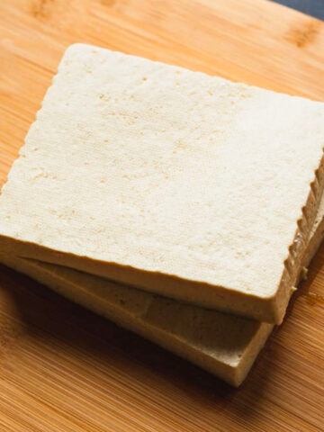 two slabs of tofu on a cutting board