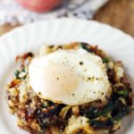 Leftover Mashed Potato Cheesy Vegetarian Hash on a white plate with a runny egg