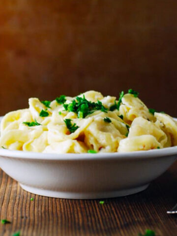 a bowl of Tortellini with Garlic Chile Oil and Feta next to a fork.