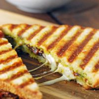 a pesto grilled cheese cut in half