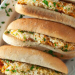three eggplant parmesan sandwiches on a platter.