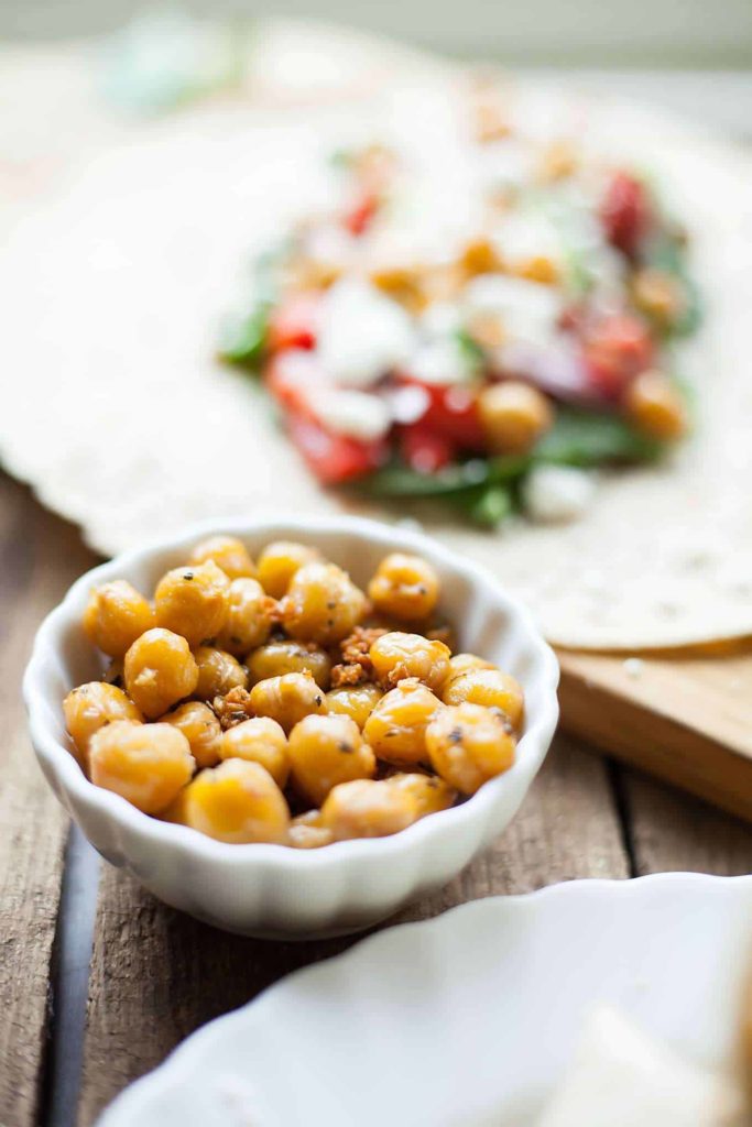 Greek Chickpea Wraps - This easy sandwich is filled with roasted chickpeas, crunchy veggies, and tangy feta cheese! I love taking these on the go. theliveinkitchen.com