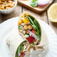 Greek Chickpea Wraps - This easy sandwich is filled with roasted chickpeas, crunchy veggies, and tangy feta cheese! I love taking these on the go. theliveinkitchen.com