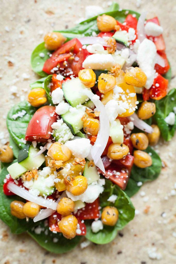 Greek Chickpea Wraps - This easy sandwich is filled with roasted chickpeas, crunchy veggies, and tangy feta cheese! I love taking these on the go. theliveinkitchen.com