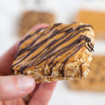 a cashew butter granola bar being held by a hand
