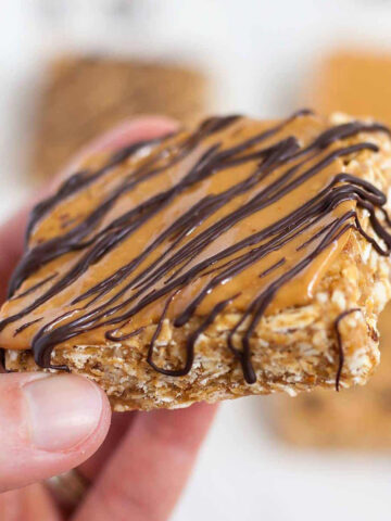 a cashew butter granola bar being held by a hand