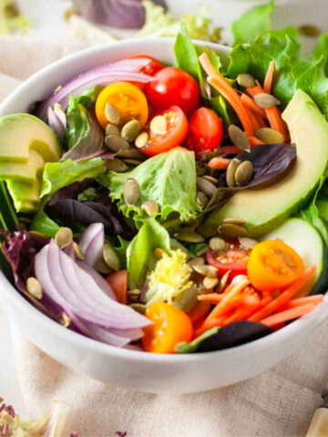 two white bowls of the best vegan salad.