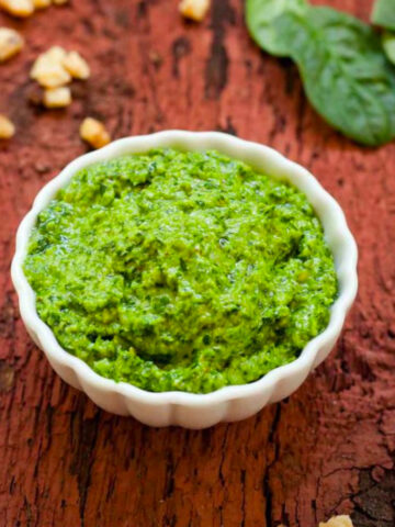 Spinach pesto in a small white bow.