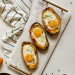 three potato skin egg boats on a platter