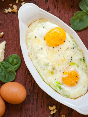 spinach and pesto baked eggs in a dish