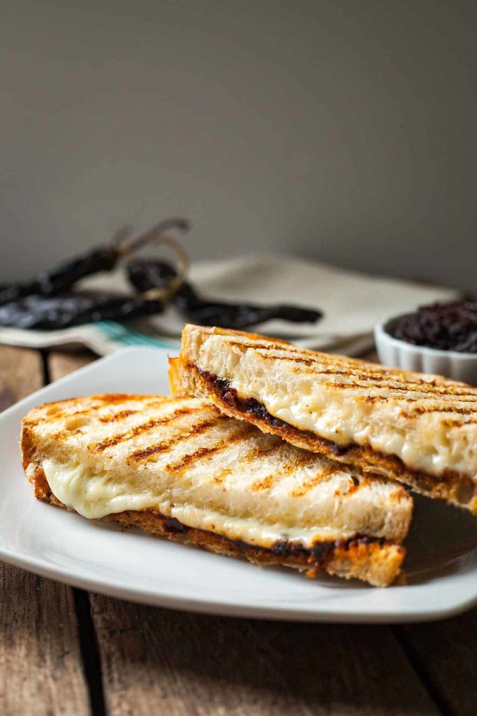 a harissa grilled cheese sandwich on a white plate