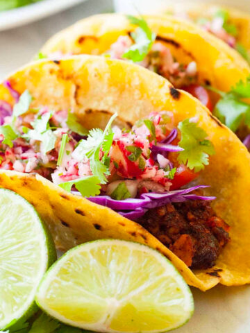 three tempeh tacos lined up on a plate
