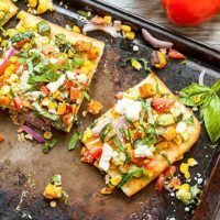 Rainbow Feta Flatbread - Roasted veggies, fresh veggies, and all the herbs! This is the best vegetarian summer meal, especially when you add a side of hummus for protein! Full recipe at theliveinkitchen.com