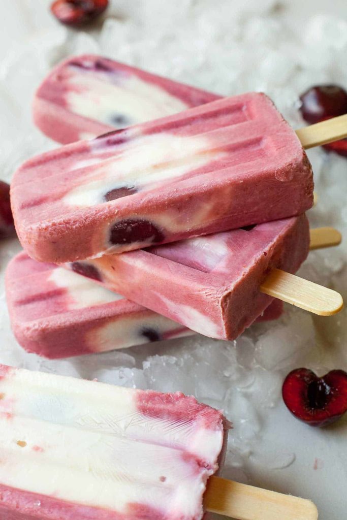 Cherry Froyo Popsicles - These frozen treats are healthy though to enjoy for breakfast! Frozen yogurt popsicles naturally sweetened with fruit and honey. My kids love these! Full recipe at theliveinkitchen.com