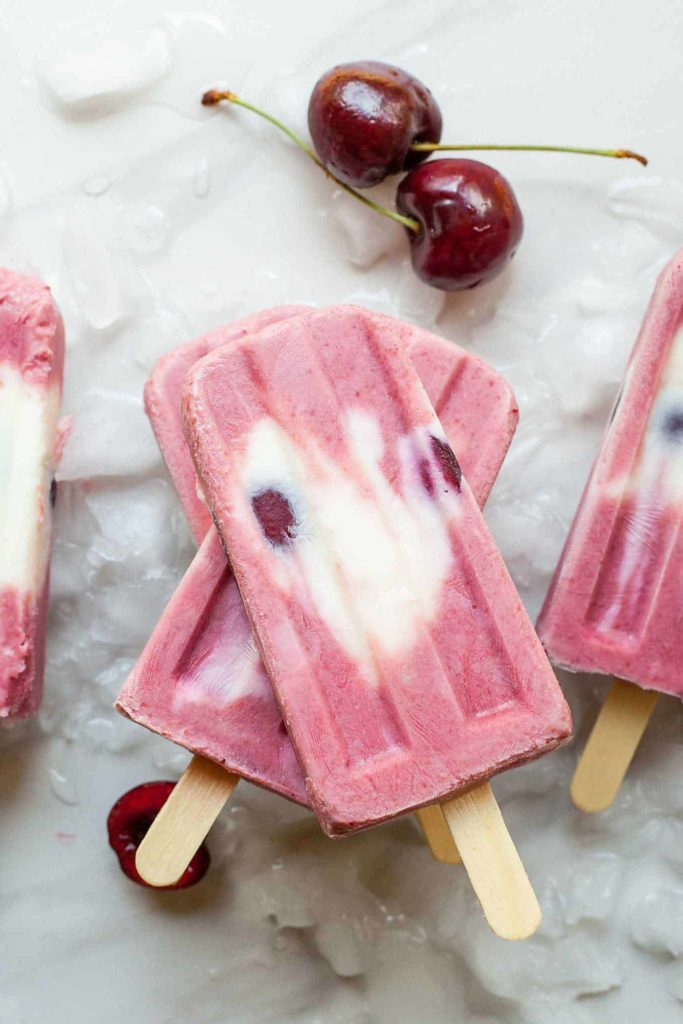Cherry Froyo Popsicles - These frozen treats are healthy though to enjoy for breakfast! Frozen yogurt popsicles naturally sweetened with fruit and honey. My kids love these! Full recipe at theliveinkitchen.com