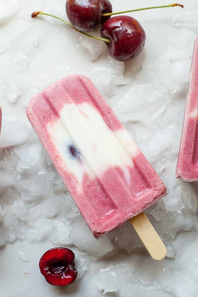 Cherry Froyo Popsicles - These frozen treats are healthy though to enjoy for breakfast! Frozen yogurt popsicles naturally sweetened with fruit and honey. My kids love these! Full recipe at theliveinkitchen.com