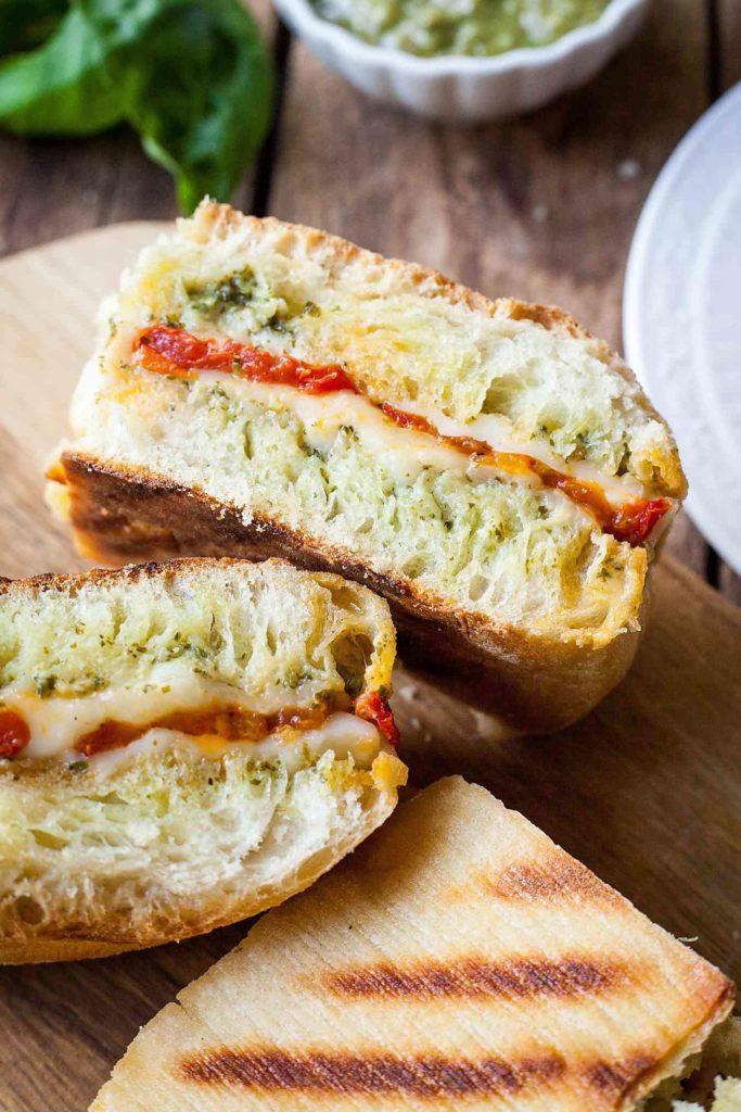 Oven Roasted Tomato and Pesto Panini - This is one of my favorite sandwiches! Fresh pesto, melty cheese, and those slow roasted tomatoes!! I can't get enough of this vegetarian sandwich. Full recipe at theliveinkitchen.com