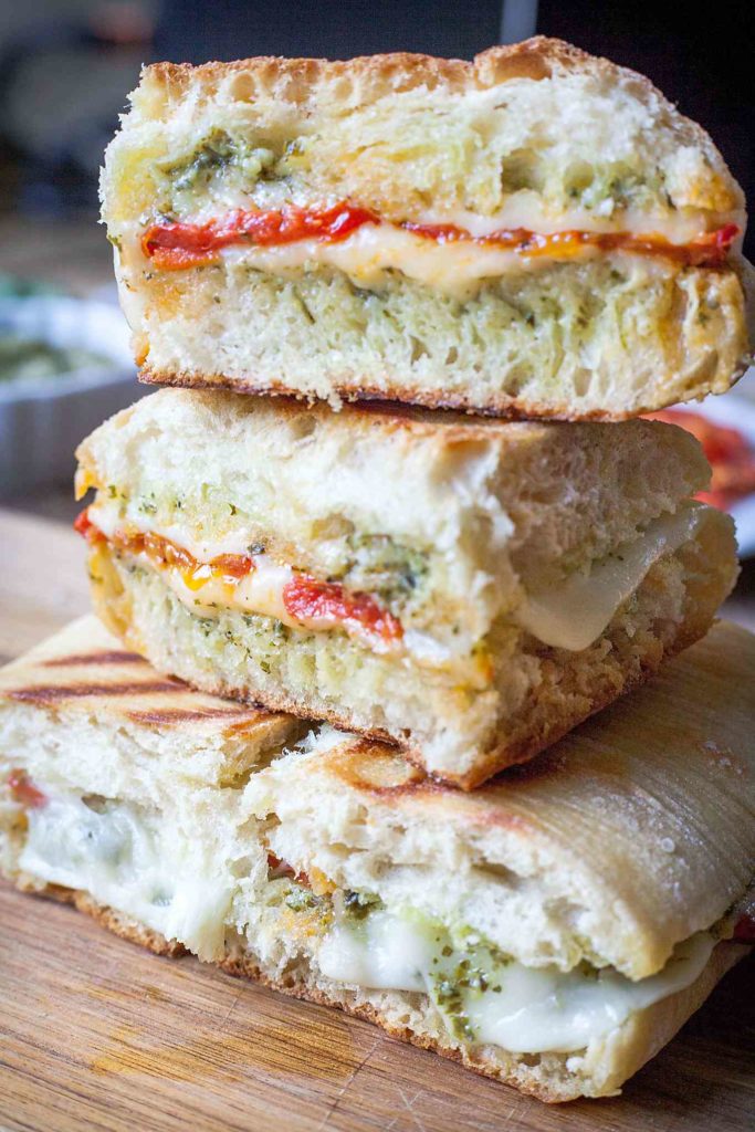 Oven Roasted Tomato and Pesto Panini - This is one of my favorite sandwiches! Fresh pesto, melty cheese, and those slow roasted tomatoes!! I can't get enough of this vegetarian sandwich. Full recipe at theliveinkitchen.com