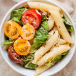caesar pasta salad in a white bowl
