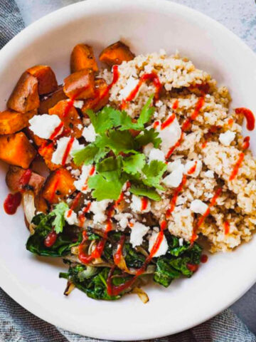 overhead photo of a sweet potato buddha bowl with a bowl of sweet potato chunks.