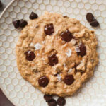 vegan chocolate chip cookie on plate .