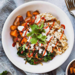 overhead photo of a sweet potato buddha bowl with a bowl of sweet potato chunks
