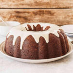 Banana Bundt Cake with Vanilla Glaze on a white plate