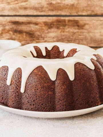 Banana Bundt Cake with Vanilla Glaze on a white plate
