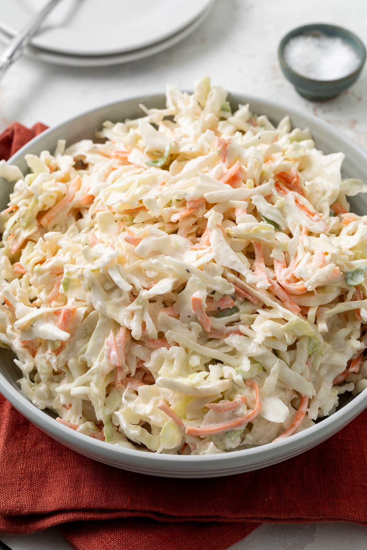 A bowl of no-mayo coleslaw on a red linen napkin.