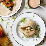 a cajun wrap cut in half on a white plate