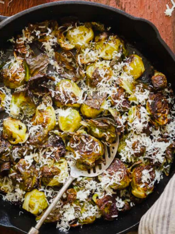 Roasted Brussels Sprouts with Parmesan in a cast iron skillet.