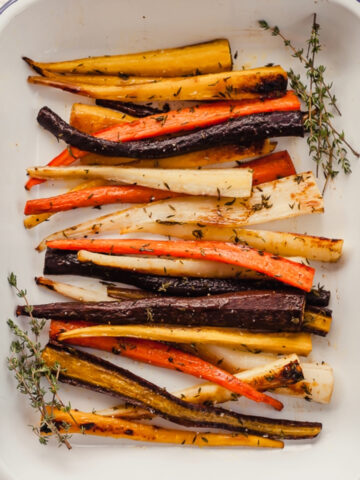 oven roasted carrots with thyme in a white dish