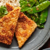 pan fried peanut tofu on a blue plate