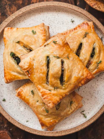 hand pies stacked on a plate.