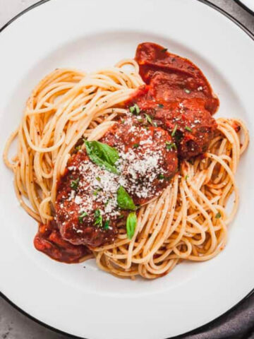 eggplant meatballs on a plate of spaghetti.
